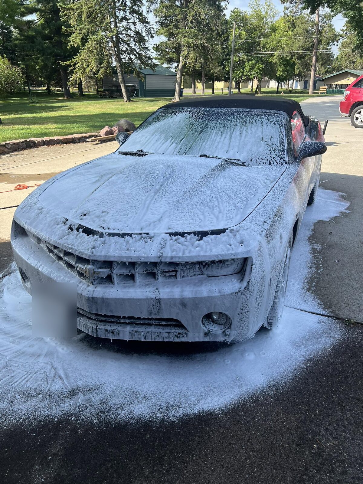 Chevrolet Camaro convertible covered in thick foam during a hand wash